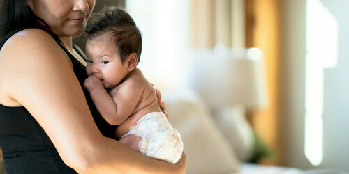 A woman holds a baby
