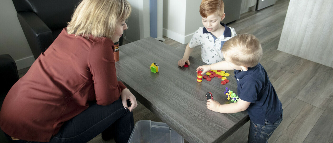 parent caregiver playing with child at daycare