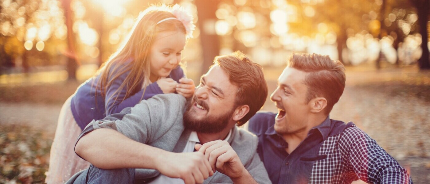 LGBTQ family love. Smiling and enjoying time outdoor.